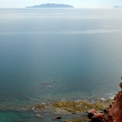 BC kayaks in distance on coast 9x6